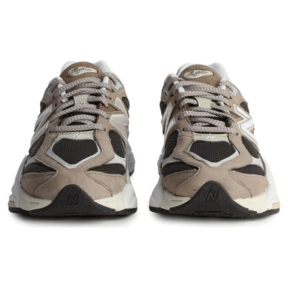 Pair of beige and black sneakers on a white background