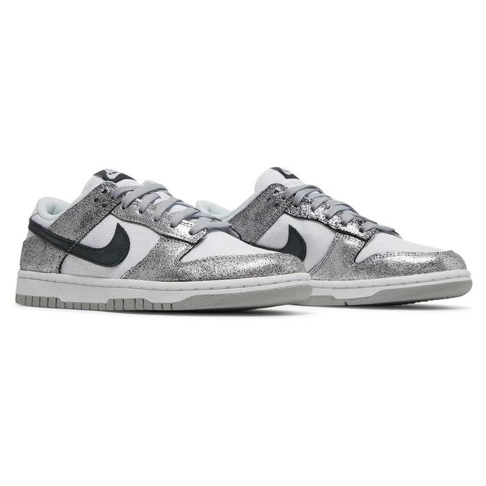 Silver glitter sneakers with black swoosh logo on a white background