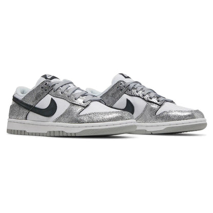 Silver glitter sneakers with black swoosh logo on a white background