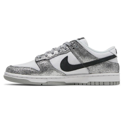 White sneaker with black swoosh logo and silver glittery side panel on a white background
