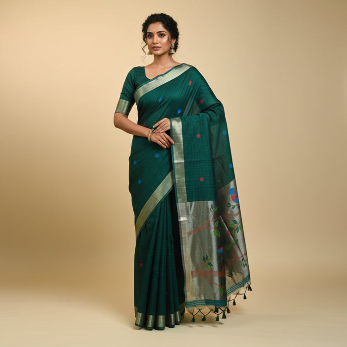 Green saree with bird and floral patterns on a neutral background