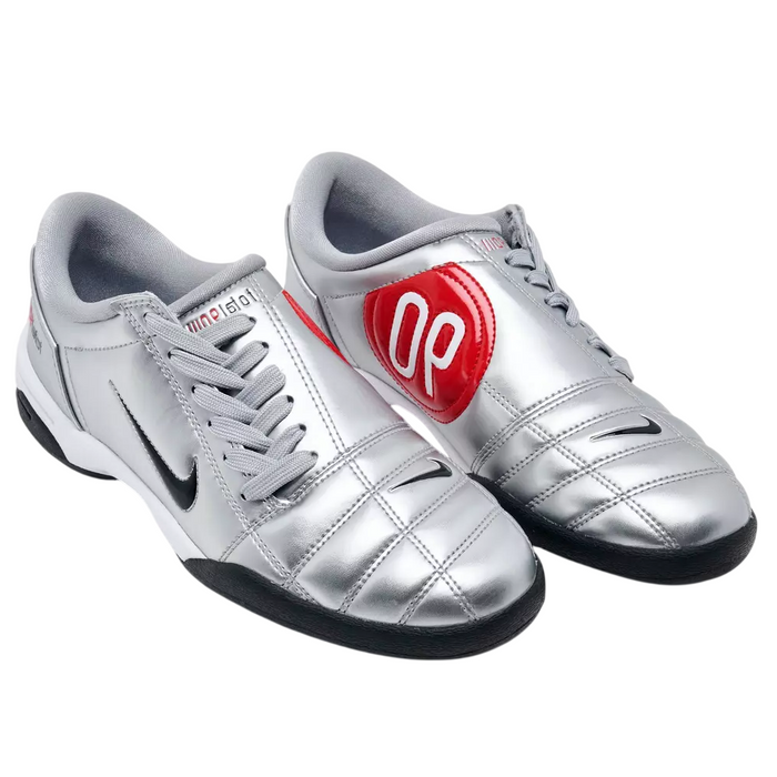 Silver sports shoes with a red heart and number 90 on a white background